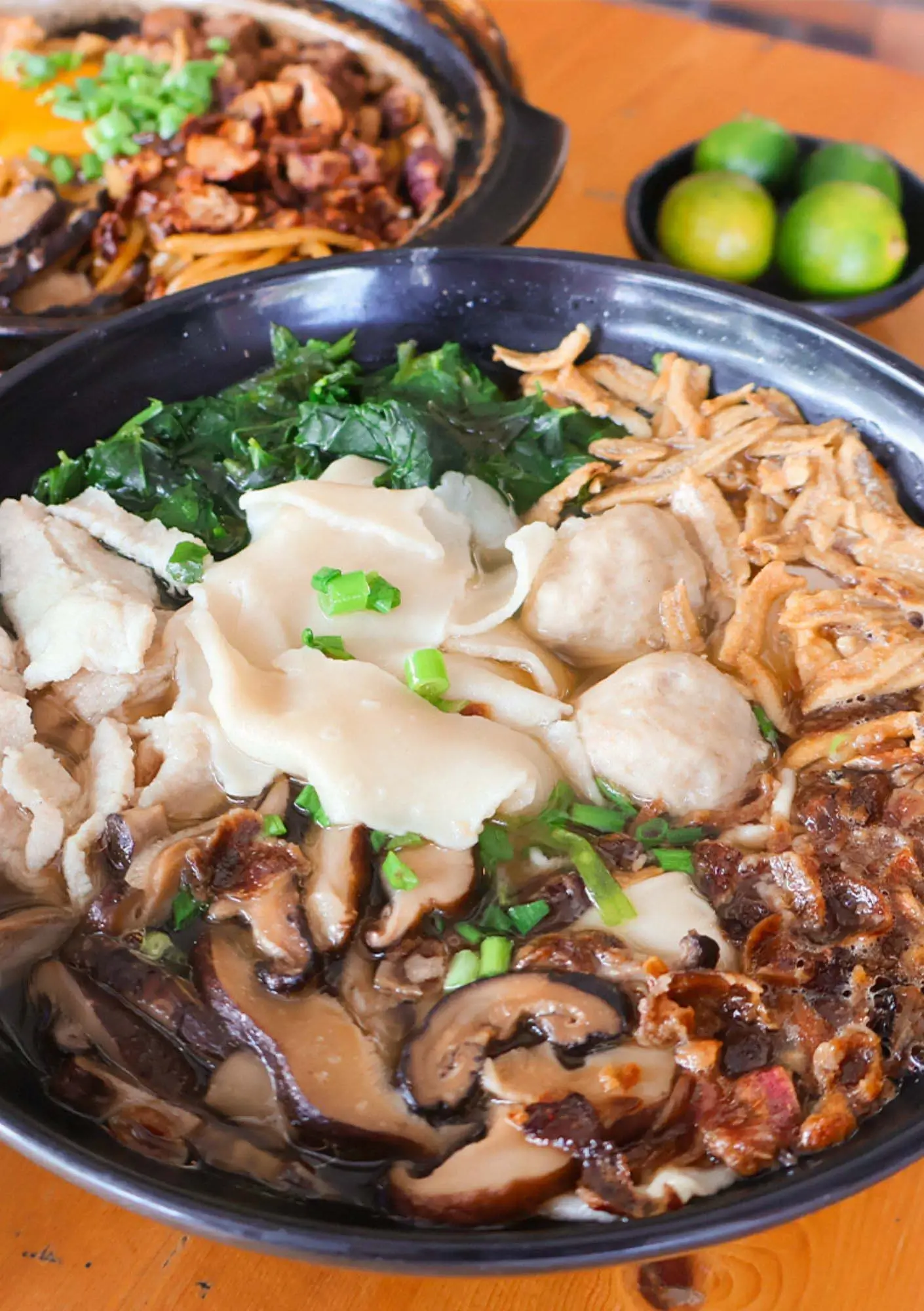 Fresh Sabah chilli pan mee soup with handmade noodles, mushrooms, leafy greens and lime garnish